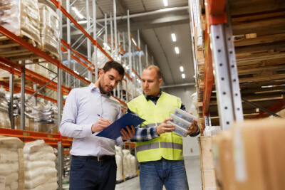 Staff reconciling inventory in warehousing facility